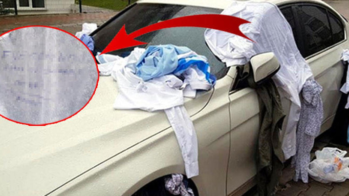 Eve gelmeyen eşinin kıyafetlerini otomobile bağladı