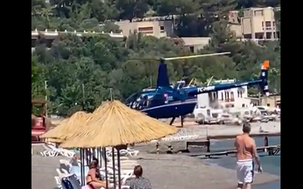 Pes dedirten görüntü! Marmaris'te yemek için halk plajına helikopterle iniş yaptılar